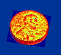 Figure 2: A silicon nanophotonic coherent imager (NCI) that uses interferometry and the chirp radar principle to capture a 3-D profile of objects from a distance. A lens is used to form an image on the NCI pixel array. Using this setup, the surface profile of a penny has been imaged from a distance of 0.5 m with an average depth resolution of 15 μm. Figure 2