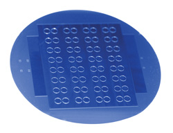 Figure 5: A silicon wafer of nonlinear optical ring resonators fabricated by the Vahala group. The devices on this wafer produce soliton waves when power is applied using a microscopic optical wire (not visible in the photo). These particular ring resonators will be used in a larger system called an optical synthesizer that is being built under support from DARPA (Defense Advanced Research Projects Agency) at the National Institute of Standards and Technology (NIST) in Boulder, Colorado. Figure 5